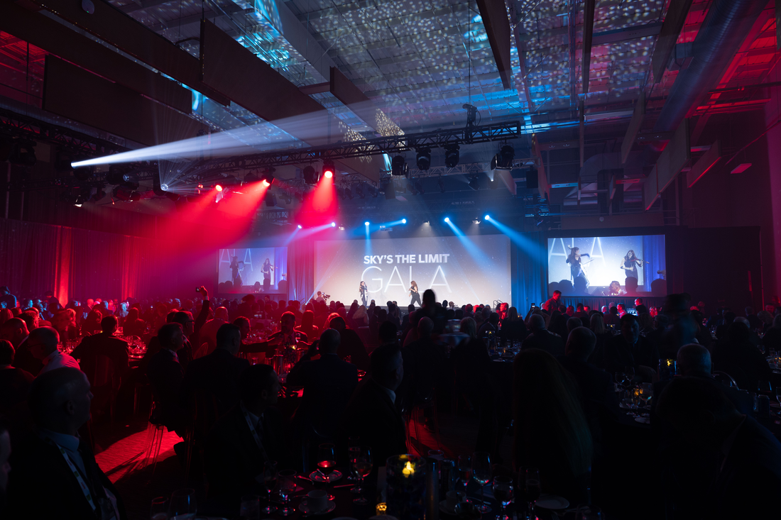 Corporate event environment with branded graphics integrated into the architecture.